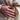 Billedet viser en ring med et unikt design, sandsynligvis lavet af Maanesten. Ringen har en organisk form med indgraverede detaljer og en skinnende overflade.