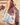 Billedet viser en lyserød totebag med teksten "Moonshine Rose". Tasken har et enkelt design og er velegnet til daglig brug.